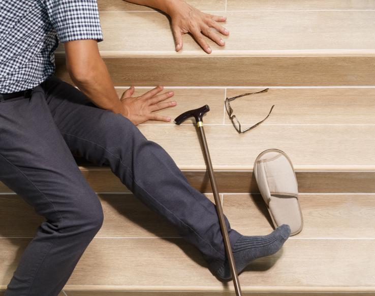 a person lying on stairs after falling