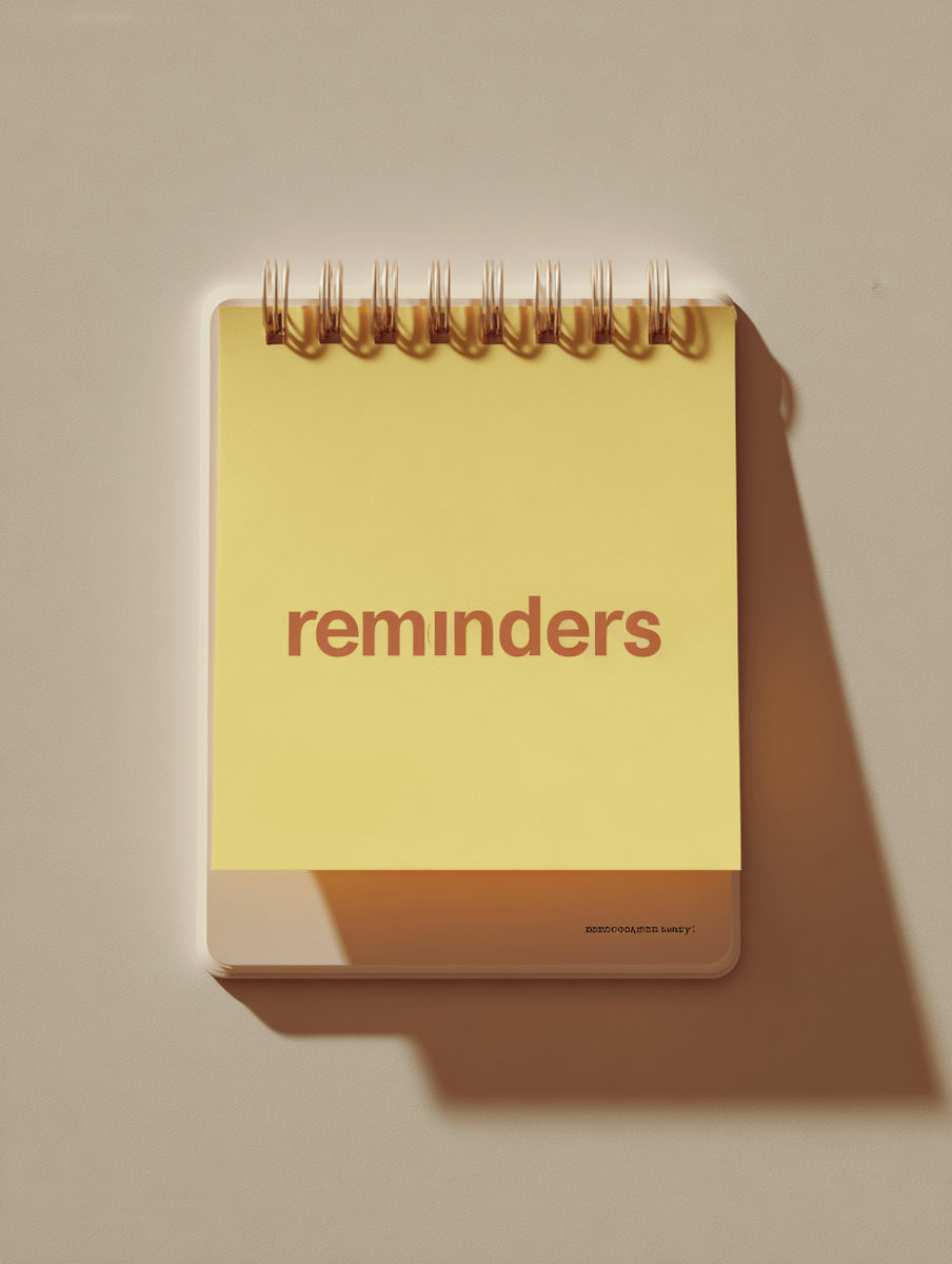 A minimalistic spiral notepad with a yellow cover and 'reminders' in bold red text, set against a beige background with soft shadows.